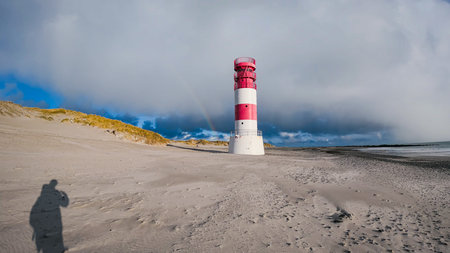 Beach view with plenty of natural grasslands and a lighthouse