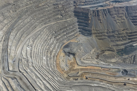 Panoramic aerial view of an open pit mine with transport equipment