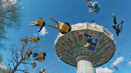 Carousel at an amusement park on a sunny and fun dayの写真素材