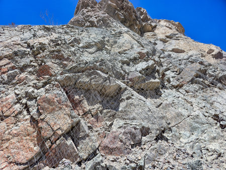 Rock slope stabilization process using steel mesh and anchor boltsの写真素材