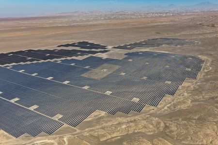 Aerial view of the cleaning process of solar panels installed in a huge photovoltaic park in the...