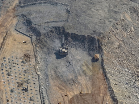 Open-pit mining operations process involving drilling, blasting, extraction, and loading of gold ore...