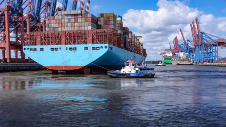 View of a huge container ship being towed to port for unloading