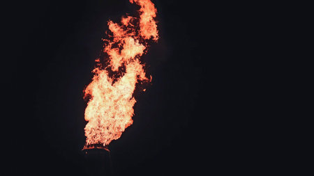 View of a flare burning excess gas at an oil refinery