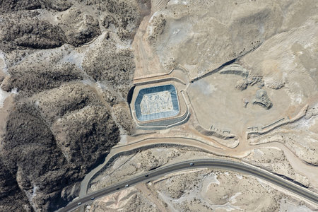 Aerial view of HDPE geosynthetic ponds next to an asphalt road