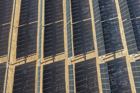 View of photovoltaic solar panel banks with mechanized solar tracking guide for maximizing solar...