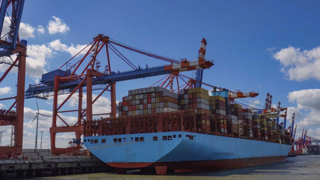 Huge container ship in the process of unloading with dock cranes