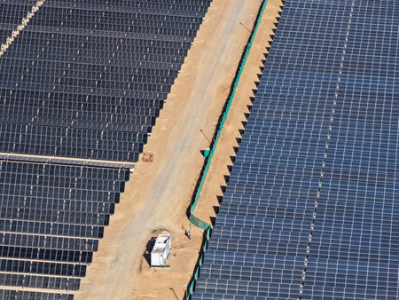 View of photovoltaic solar panel banks with mechanized solar tracking guide for maximizing solar...