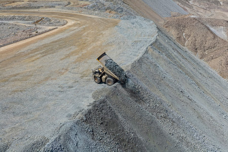 Rock dumping process at a mining waste dump using a huge mining truck