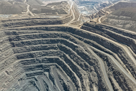 Panoramic view of a beautiful open-pit iron mine alongside roads and spoil heaps