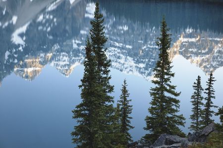 Reflections in the turquoise colored waters of Moraine Lake in the Valley of Ten Peaks in Banff National Park, Alberta Canada.の写真素材