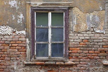 Old window with plaster and brick wall fallen in in ruins in Zagreb. Zagreb is the capitol of the Republic of Croatia and not only the heart of political activity but also economic and cultural. Present Zagreb has developed from two medieval settlements, の写真素材