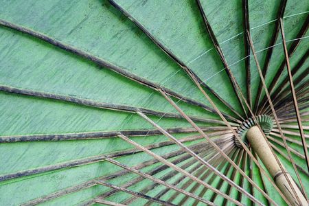 The underside of a cotton umbrella with colorful painted flowers showing the bamboo ribs handmade at the Umbrella Making Centre in Bo Sang, Thailand. Bo Sang is known as the Umbrella Village but is also known for its silk, pottery and wood carving factoriの写真素材