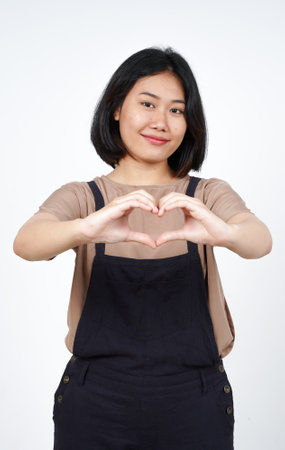Asian woman in apron making heart shape with hands on white backgroundの写真素材