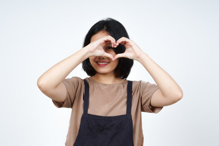 Portrait of a beautiful asian woman making a heart with her hands isolated on a white backgroundの写真素材