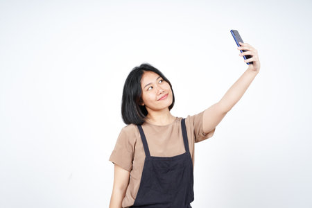 Take a Selfie using Smartphoneof Beautiful Asian Woman Isolated On White Backgroundの写真素材