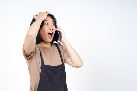 Talking on the smartphone and forget something of Beautiful Asian Woman Isolated On White Backgroundの写真素材