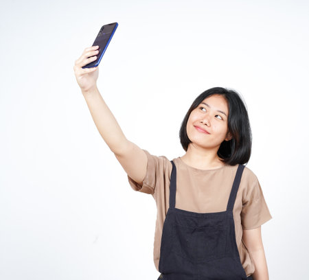 Take a Selfie using Smartphoneof Beautiful Asian Woman Isolated On White Backgroundの写真素材