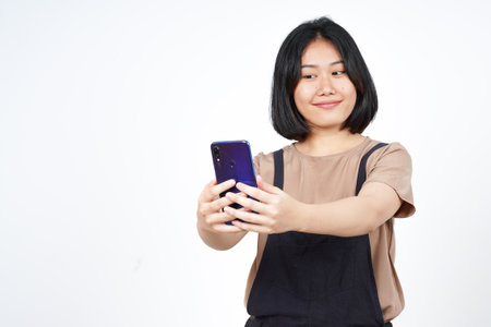 Take a Selfie using Smartphoneof Beautiful Asian Woman Isolated On White Backgroundの写真素材