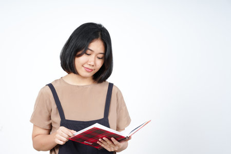 Portrait of a beautiful asian woman reading a book isolated on a white backgroundの写真素材