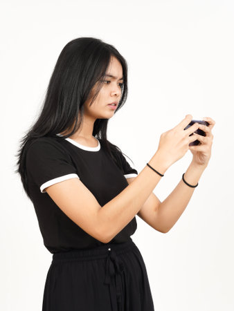 Playing Mobile Game on Smartphone Of Beautiful Asian Woman Isolated On White Backgroundの写真素材
