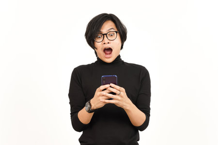 Holding and Using Smartphone With Shocked Face Of Handsome Asian Man Isolated On White Backgroundの写真素材