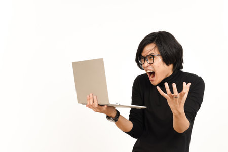 Shock and Angry While Using Laptop Of Handsome Asian Man Isolated On White Backgroundの写真素材