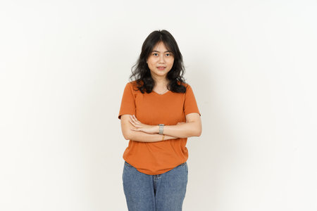 young asian woman wearing orange t-shirt standing with arms crossedの写真素材