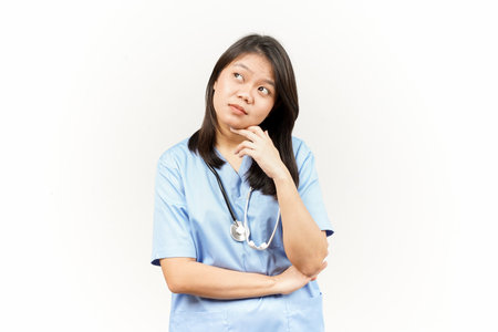 Thinking and Curious Of Asian Young Doctor Isolated On White Backgroundの写真素材