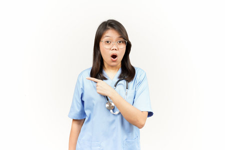 Showing Product and Pointing Side Of Asian Young Doctor Isolated On White Backgroundの写真素材