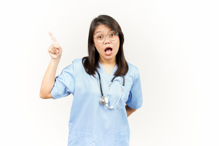 Showing Product and Pointing Side Of Asian Young Doctor Isolated On White Backgroundの写真素材
