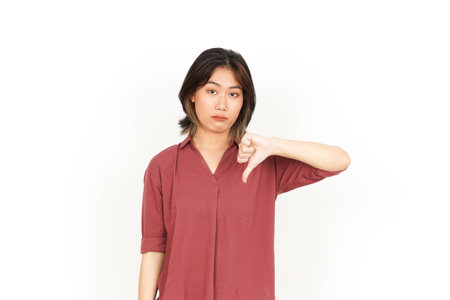 Young asian woman showing thumbs down sign on white background with copy spaceの写真素材