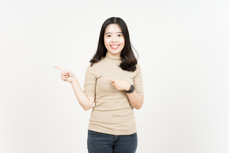 Showing Product and Pointing Side Of Beautiful Asian Woman Isolated On White Backgroundの写真素材
