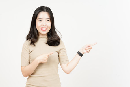 Showing Product and Pointing Side Of Beautiful Asian Woman Isolated On White Backgroundの写真素材