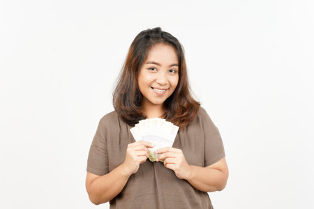 Holding banknote one thousand rupiah of Beautiful Asian Woman Isolated On White Backgroundの写真素材