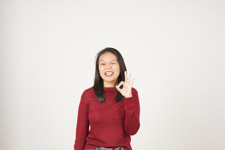 Young Asian woman in Red t-shirt smiling and showing okay sign isolated on white backgroundの写真素材