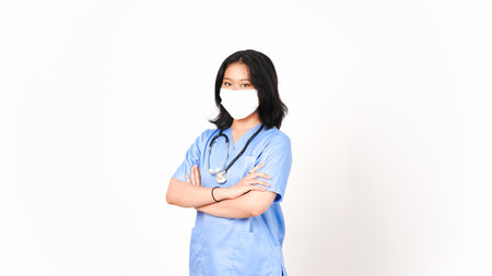 Young Asian female doctor using medical mask holding arms and looking at camera isolated on white backgroundの写真素材