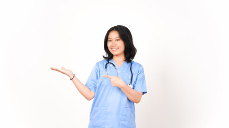 Young Asian female doctor pointing copy space on palm hand isolated on white backgroundの写真素材