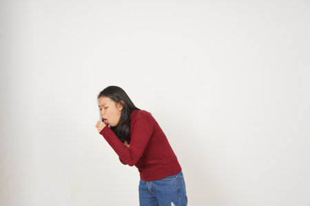 Young Asian woman in Red t-shirt coughing isolated on white backgroundの写真素材