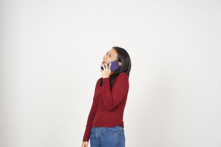 Young Asian woman in Red t-shirt Make a phone call with smartphone isolated on white backgroundの写真素材
