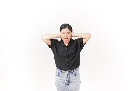 Young Asian woman Hears bothering noise, Covering ears wearing Black t-shirt and jeans isolated on white backgroundの写真素材