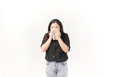 Young Asian woman suffering flu hand holding tissue wearing Black t-shirt and jeans isolated on white backgroundの写真素材