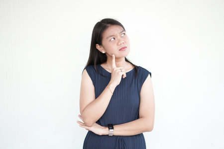 Beautiful Asian Woman wearing formal dress Thinking concept Isolated On White Backgroundの写真素材
