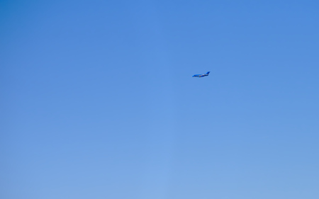 blue aricraft in blue skyの写真素材
