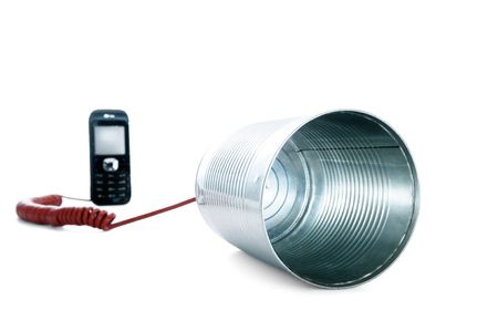 Tin can phone wired to a mobile phone over white background.の写真素材