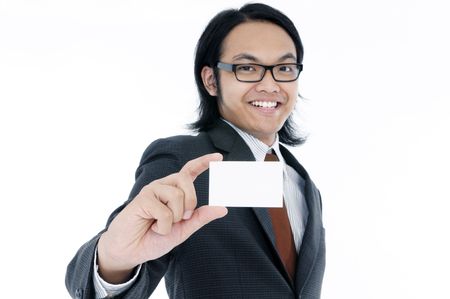 Portrait of a happy young man holding a blank card over white background. Focus on the hand and card.の写真素材