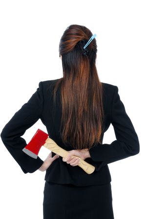 Businesswoman holding an axe behind her back, isolated on white.の写真素材