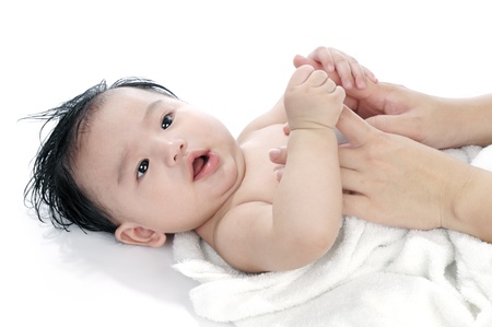 Portrait of a cute infant baby lying on back, over white background.の写真素材