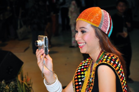 Kuching, Malaysia - June 14, 2008 - The native beauty of Sarawak taking photo during Malaysia Gawai Dayak Open House celebration in Kuching.のeditorial素材