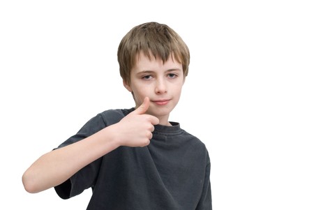 A young boy saying ok with a thumbs up hand sign.の写真素材